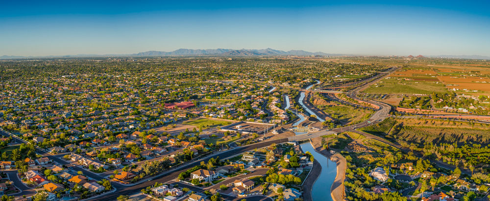 Aerial view of the canals, neighborhoods and farmlands of the Greater Phoenix area, home to an affordable lifestyle.