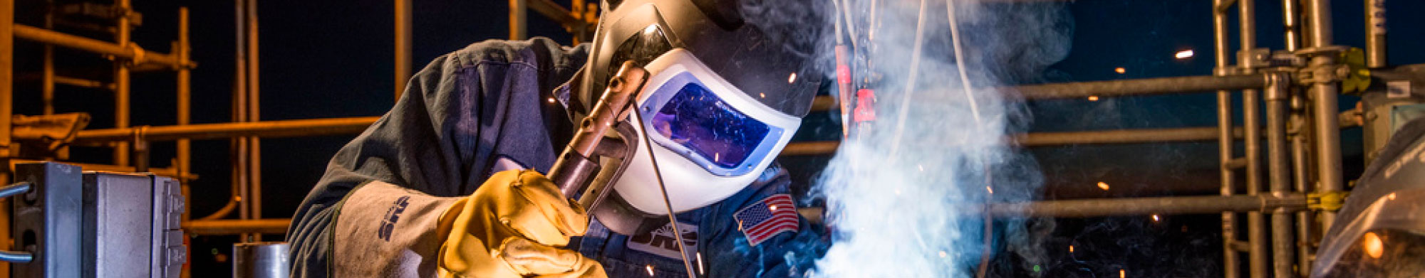 A welding specialist working in the field of advanced manufacturing. Information panels (could be used for all if necessary): A printed circuit board assembly in process.