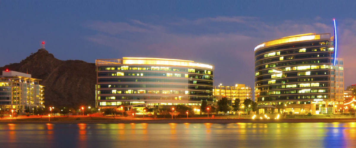 Tempe town lake and surrounding area lit up at night.