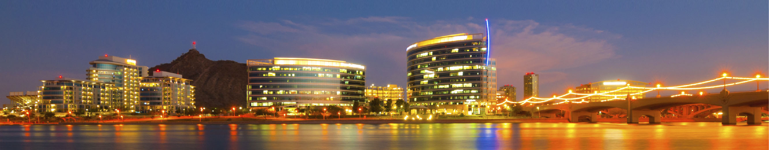 Tempe town lake and surrounding area lit up at night.