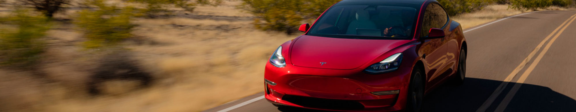 A red Tesla racing through the Arizona desert, a naturally dry climate that's ideal climate for testing